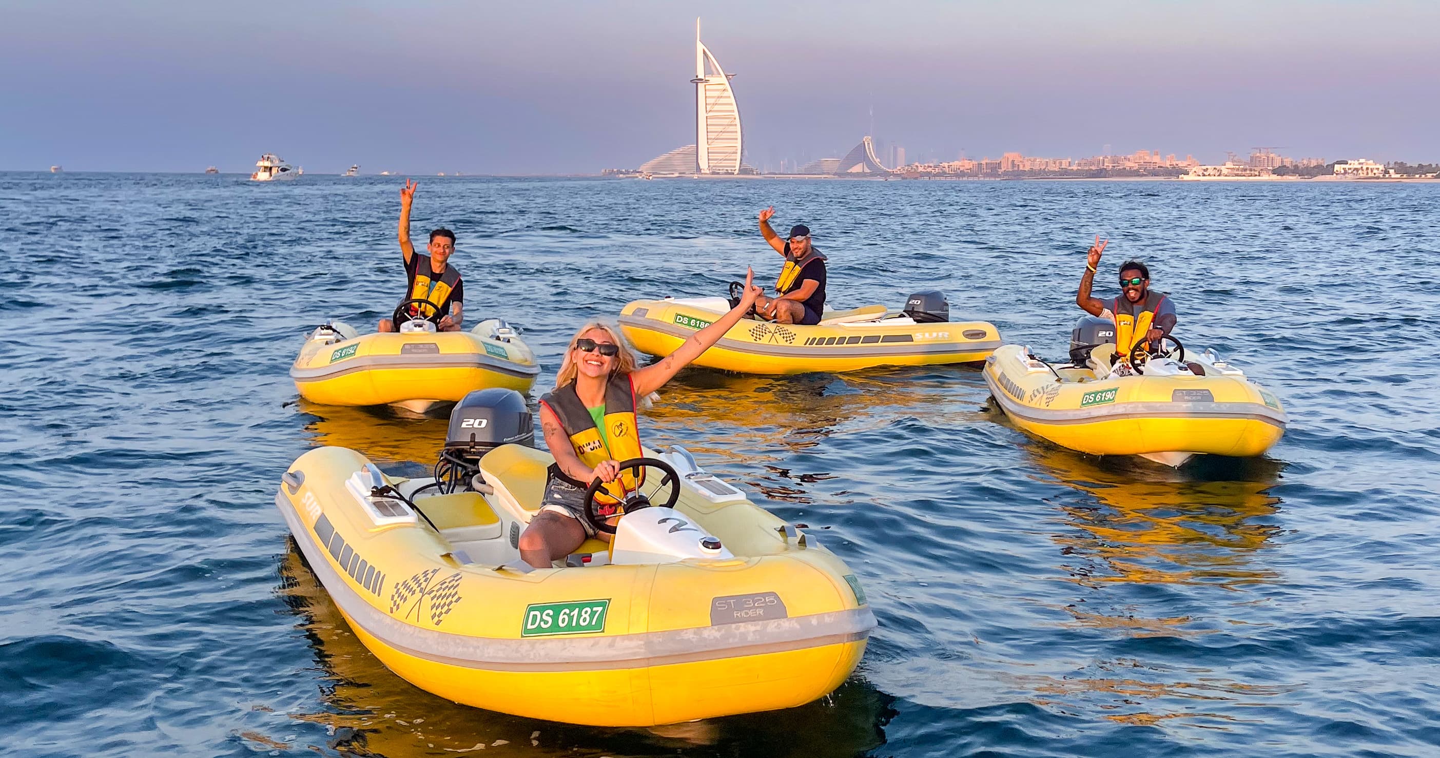 Costa Viva self-drive fleet on the water at golden hour with the Burj Al Arab in the background