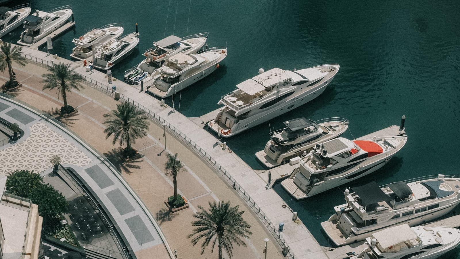 Self-drive boats passing Ain Dubai at golden hour